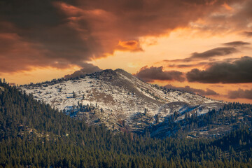 A gorgeous winter landscape with snow capped mountains surrounded by lush green trees at Lake Tahoe...