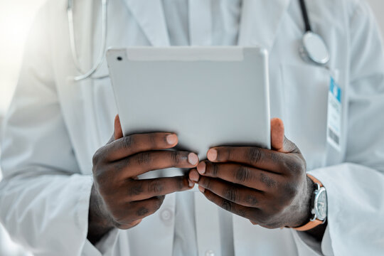 Tablet, man and hands of surgeon in hospital for telehealth consultation and online medical report. Digital technology, research and male healthcare worker reading surgery or treatment plan in clinic