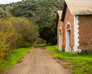 Muddy Road Passes Building At Prisioners Harbor On Santa Cruz Island