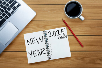 2025 Happy New Year Resolution Goal List and Plans Setting - Business office desk with notebook written about plan listing of new year goals and resolutions setting. Change and elation concept.