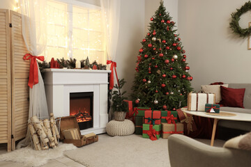 Fototapeta premium Stylish interior of living room with beautiful fireplace, folding screen, Christmas tree and presents