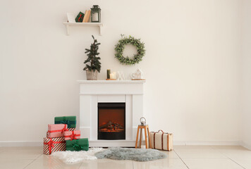 Interior of light room with fireplace, Christmas tree and presents