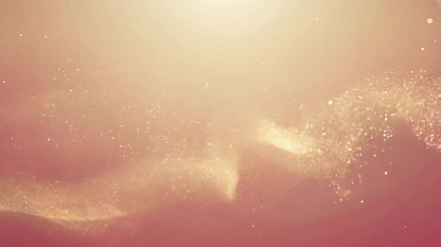 Golden particles flow gracefully on a rose gold background, forming captivating abstract shapes and textures