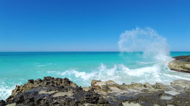 Waves crash along the rocky shore of the Bimini Islands in the Bahamas.