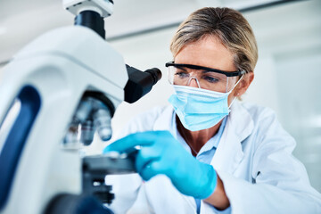 Mature woman, scientist and microscope with face mask in science lab for medical research or study....