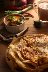 Classic Malaysia flat bread with curry and milk tea.