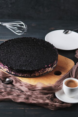 Cheesecake with jelly and berries. Dessert on a wooden board and a cup of espresso.