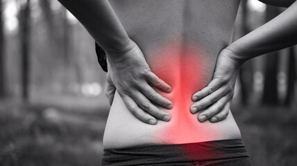 close up photo of a person holding a sore back