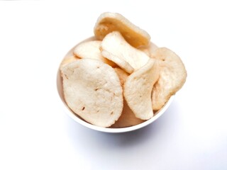 A pile of shrimp crackers in a small bowl. Shrimp crackers are made from a mixture of tapioca flour and finely pounded shrimp with spices and flavor enhancers. A snack from Sidoarjo, Indonesia.