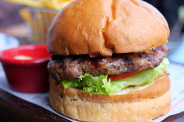 Cheeseburger With Salad And Tomato On a wooden board 
