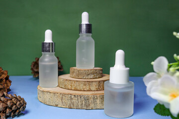 unbranded cosmetic bottles for skincare product promotion, with green background and wooden podium and flowers around it