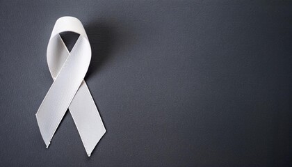 Lung Cancer Awareness Symbol. White Ribbon with Copy Space for Text. Dark Gray Background Isolated. Flat Lay Top View.