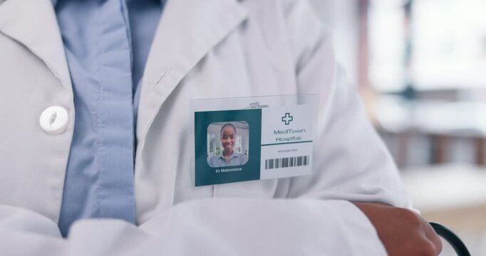 Name tag, healthcare and doctor in hospital with crossed arms for confidence in medical service. Pride, closeup and surgeon with badge for career in cardiology at clinic for health insurance.