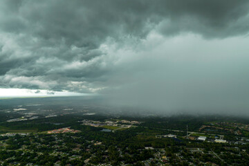 Rain shower water pouring down from stormy clouds during summer thunderstorm in rural Florida