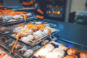 New baked goods in the supermarket on the shelves in festive packaging