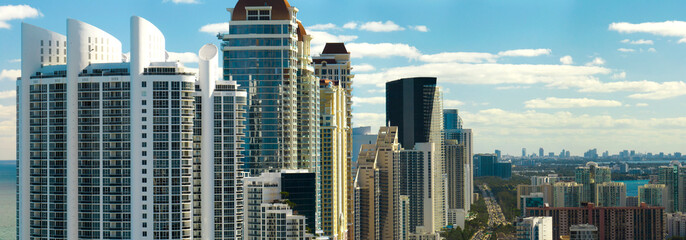 Sunny Isles Beach city with luxurious highrise hotels and condo buildings on Atlantic ocean shore. American tourism infrastructure in southern Florida