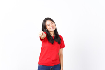 Fototapeta premium Smiling and Pointing at camera or you, want you gesture Of Beautiful Asian Woman wearing red shirt Isolated On White Background