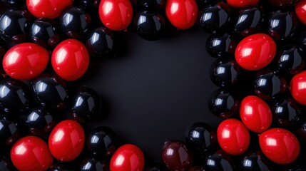 A vibrant and elegant display of red and black balloons arranged symmetrically on a sleek black backdrop, with glossy reflections emphasizing the texture of the balloons, under soft studio lighting