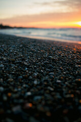 sunset on the beach focused on pebbles