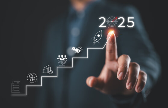 2025 New Year Business Goals Concept. Businessmen point to "2025" as a staircase, steps toward achieving business goals, growth, Planning and challenge, investor's target and success in the new year
