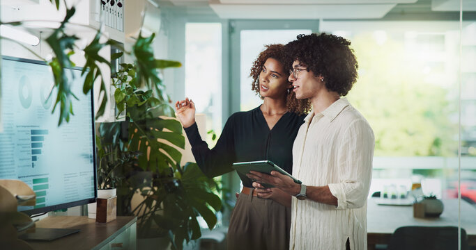 Man, woman and tablet by monitor at startup with review, stats or brainstorming with graphs for sustainability. People, partnership and touchscreen on app, sustainable and climate consulting agency