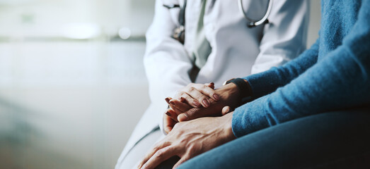 Holding hands, doctor and patient with compassion, consultation or advice with healthcare in...