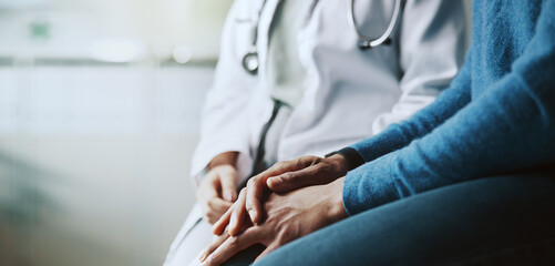 Doctor, hands and empathy with patient for consultation, breaking news or clinic results at...