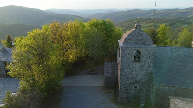 Aerial tracking shot from Cebreiro church with morning sunrays, Lugo, Spain