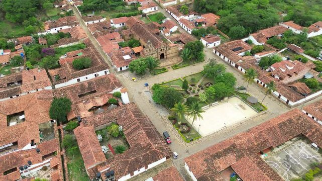 Aerial estabilshing pan of Guane historic square surrounded by colonial buildings, cobblestone streets, Colombia