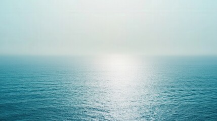 Fototapeta premium Serene Ocean Surface Under a Hazy Sky