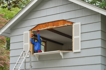 contractor working on replacing the window of the house