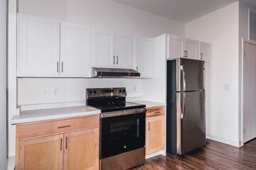 Modern kitchen apartment with island and appliances.