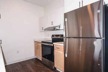 Modern kitchen apartment with island and appliances.