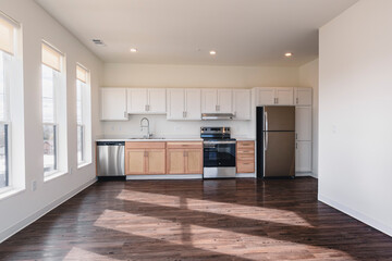 Modern kitchen apartment with island and appliances.