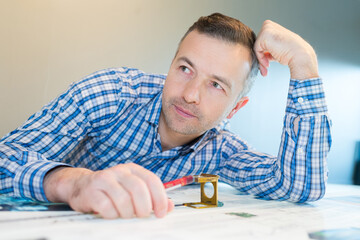 using magnifying glass to check the print quality