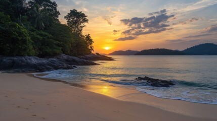 Obraz premium Serene tropical sunset reflecting on sandy beach with lush greenery and calm waters creating a peaceful coastal scene