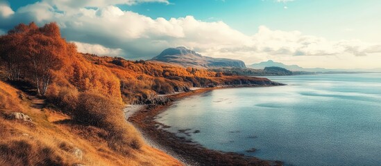 Serene autumn landscape showcasing a vibrant coastline with scenic hills and tranquil waters under a bright sky