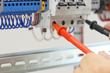 Measurement of electrical parameters in a switchboard using a multimeter. Soft focus. 