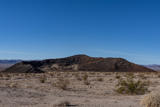 A cinder cone (or scoria cone) / Basalt Flow / volcano. U.S. Route 66 or U.S. Highway 66 / National Trails Hwy, Bagdad,  San Bernardino County, California.  Mojave Desert / Basin and Range Province. 
