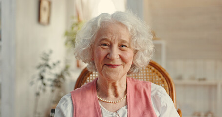 Portrait, senior woman and smile in retirement or nursing home for elderly care, health and...
