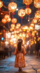 A young girl in traditional attire stands surrounded by glowing lanterns during a vibrant night...