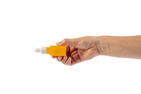 Yellow glass cosmetic bottle and hand, Skin care or sunscreen cosmetic on transparent background.