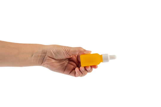 Yellow glass cosmetic bottle and hand, Skin care or sunscreen cosmetic on transparent background.