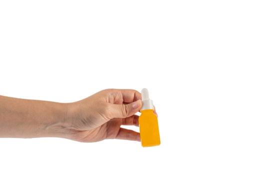 Yellow glass cosmetic bottle and hand, Skin care or sunscreen cosmetic on transparent background.