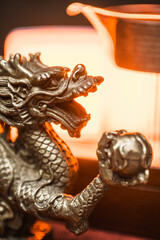 An Intricate Silver Dragon Statue featuring a Glowing Background for an enchanting effect