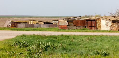 A rural area with a few old shacks and a dirt road