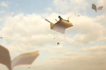 woman reads lying on the pages of a book that fly like birds in the sky