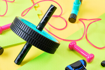 Exercise equipment on a colorful puzzle mat background.