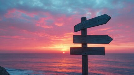 Wooden signpost with blank directional arrows at sunrise over the ocean.