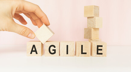 Word Agile writen with wood cubes on a light background